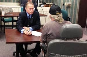 Eric Torberson giving legal advice to veteran Criminal Attorney Eric Torberson assisting veteran at legal clinic.